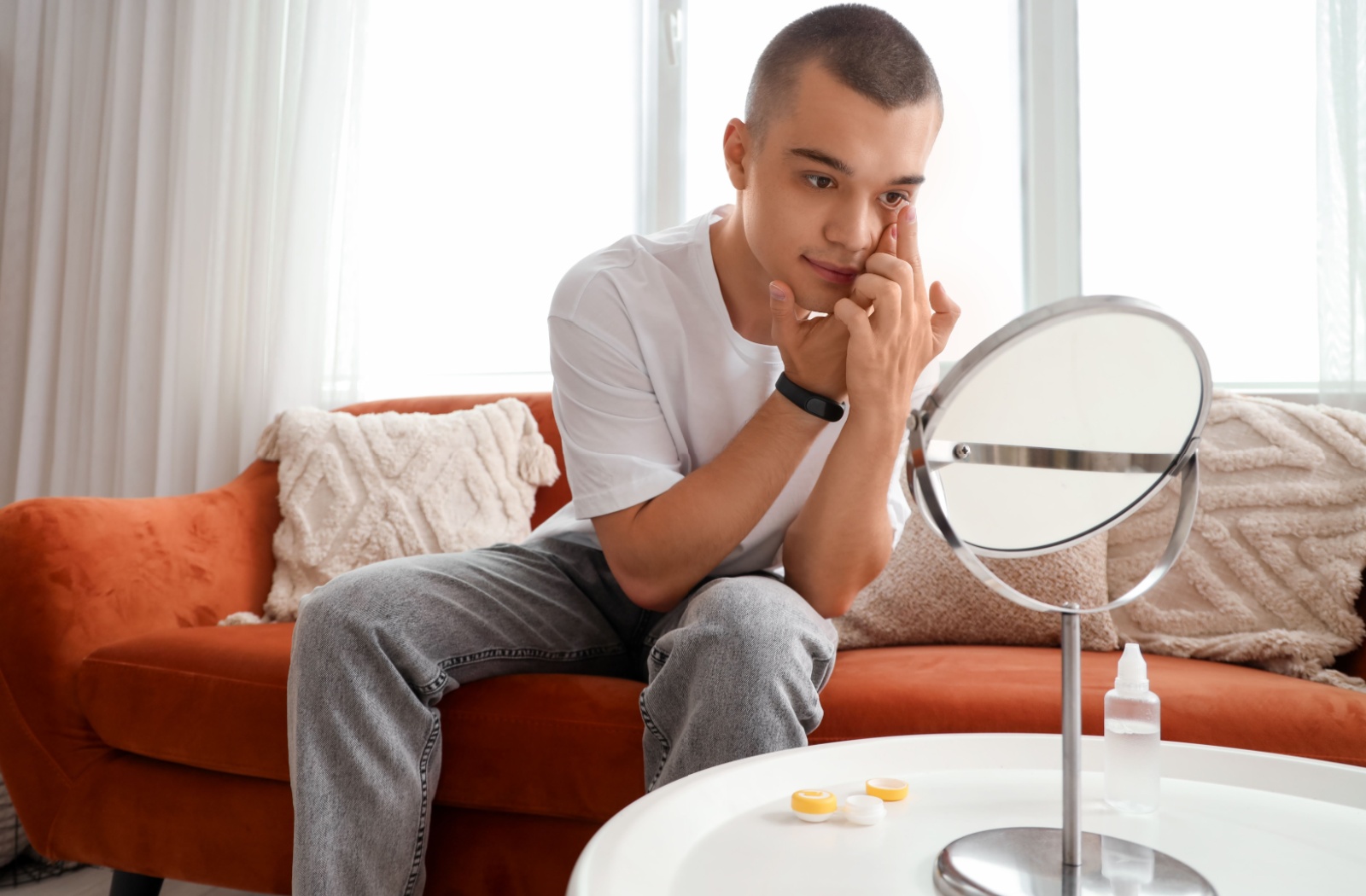 A teenager puts their myopia control soft contact lenses in before heading to school.